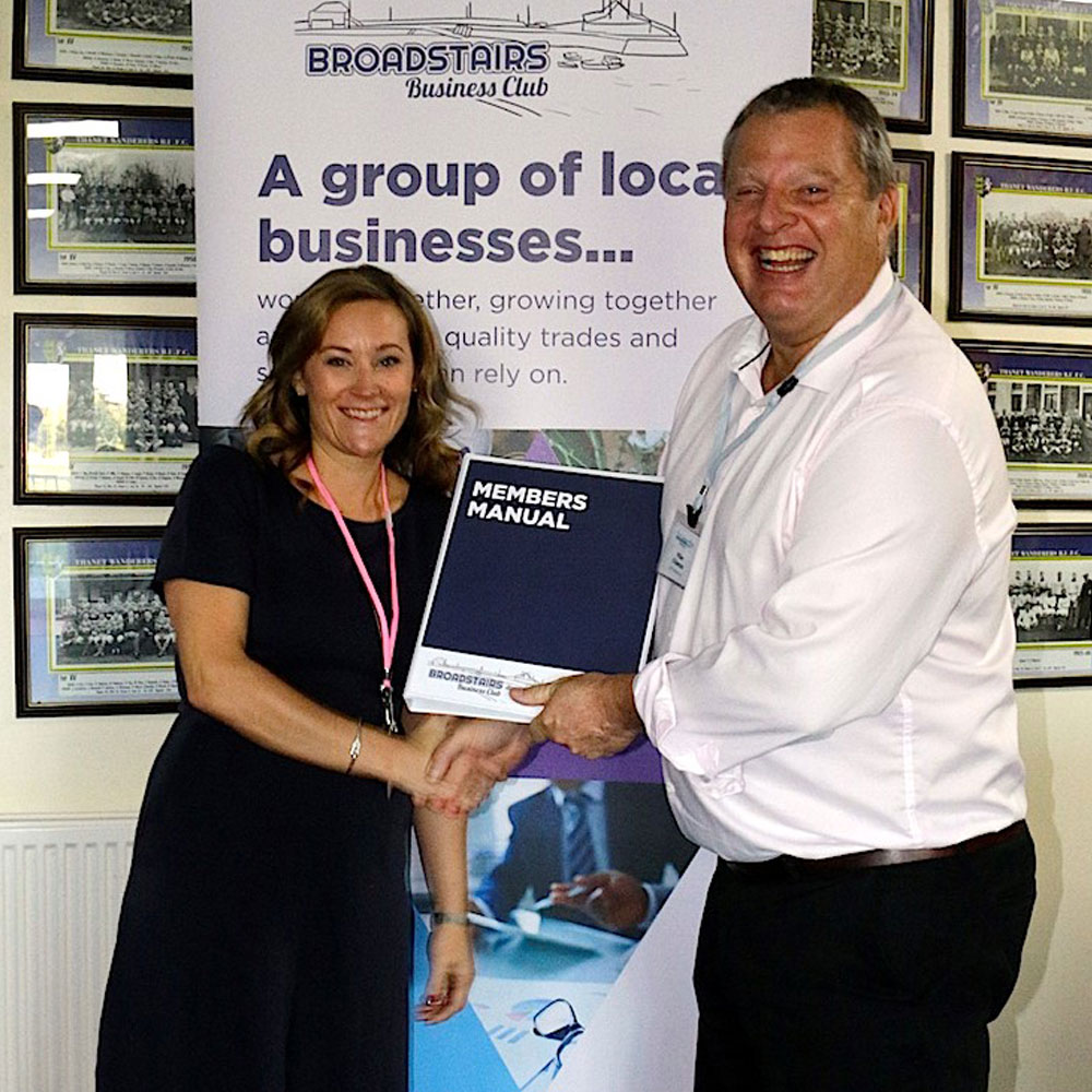 Photo of Katy Hooper, Broadstairs MOT Centre receiving her membership manual from chairman, Mike Chance